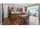 A gourmet kitchen is showcased with custom cabinets, granite counters and stainless steel appliances at 2100 Della Ct, Apex, NC 27502