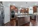 A gourmet kitchen is showcased with custom cabinets, granite counters and stainless steel appliances at 2100 Della Ct, Apex, NC 27502