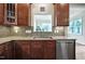 A gourmet kitchen is showcased with custom cabinets, granite counters and stainless steel appliances at 2100 Della Ct, Apex, NC 27502