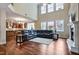 Spacious living room featuring a fireplace, large sectional, and an open view to the kitchen at 2100 Della Ct, Apex, NC 27502