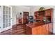 A cozy home office featuring hardwood floors, built-in shelves, and a comfortable leather chair at 2100 Della Ct, Apex, NC 27502