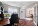 Bright office space with hardwood floors, a large window, and French doors at 2100 Della Ct, Apex, NC 27502