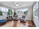 Sun-filled sunroom with large windows offering bright sunlight and backyard views at 2100 Della Ct, Apex, NC 27502