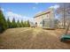A spacious backyard featuring a grassy area and a trampoline, adjacent to the home's exterior at 224 Swann Trl, Clayton, NC 27527