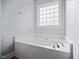 Relaxing bathtub nook with a privacy window for natural light at 224 Swann Trl, Clayton, NC 27527