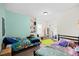 Cozy bedroom featuring twin beds, colorful bedding, and a window for natural light at 224 Swann Trl, Clayton, NC 27527