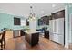 Beautiful kitchen with dark cabinets, a granite island, and stainless steel appliances at 224 Swann Trl, Clayton, NC 27527