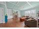 Spacious living room with a stone fireplace, built-in shelving, and coffered ceilings at 224 Swann Trl, Clayton, NC 27527