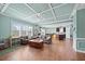 Open-concept living room with coffered ceilings, hardwood floors, and a seamless flow to the kitchen at 224 Swann Trl, Clayton, NC 27527