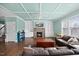 Bright living room with coffered ceiling, stone fireplace, custom built-ins, and large windows at 224 Swann Trl, Clayton, NC 27527