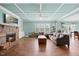 Comfortable living room with a stone fireplace, coffered ceilings, and ample natural light at 224 Swann Trl, Clayton, NC 27527