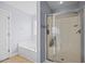 Modern bathroom features a soaking tub and a glass-enclosed walk-in shower at 224 Swann Trl, Clayton, NC 27527