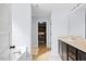 Bright bathroom features a single vanity, a luxurious soaking tub, and access to a walk-in closet at 224 Swann Trl, Clayton, NC 27527