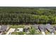 Aerial view of the home with a large wooded area behind the property, offering privacy and a sense of nature at 2329 Field Poppy Dr, Apex, NC 27502