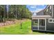 Beautiful backyard view showcasing the screened-in porch and well-maintained lawn at 2329 Field Poppy Dr, Apex, NC 27502