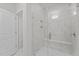 Modern tiled shower boasts glass doors, a built-in niche, and a comfortable bench at 2329 Field Poppy Dr, Apex, NC 27502