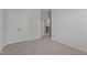 Carpeted bedroom with double closets with access to the hallway at 2329 Field Poppy Dr, Apex, NC 27502