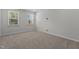 Cozy bedroom featuring carpet and two windows with wooded views at 2329 Field Poppy Dr, Apex, NC 27502