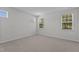 Bedroom with carpet and two large windows at 2329 Field Poppy Dr, Apex, NC 27502