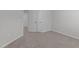 Neutral-toned bedroom with plush carpet, large closets, and a view into the hallway at 2329 Field Poppy Dr, Apex, NC 27502