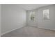 Bright bedroom with neutral carpet and two windows offering ample natural light at 2329 Field Poppy Dr, Apex, NC 27502