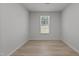 This bedroom has a window and wood-look flooring at 2329 Field Poppy Dr, Apex, NC 27502