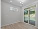 Dining area features sliding door, light-colored wood flooring, and natural light at 2329 Field Poppy Dr, Apex, NC 27502