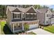 Charming two-story home featuring a brick facade, a two-car garage and manicured lawn at 2329 Field Poppy Dr, Apex, NC 27502