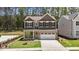 Charming two-story home with brick accents, a two-car garage, and landscaped front yard at 2329 Field Poppy Dr, Apex, NC 27502
