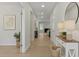Bright hallway featuring wood floors, neutral walls, and decorative accents leading to the living area at 2329 Field Poppy Dr, Apex, NC 27502