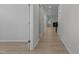 Bright hallway featuring wood floors, neutral walls, and decorative accents leading to the living area at 2329 Field Poppy Dr, Apex, NC 27502