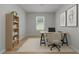 Bright home office featuring a large desk, comfortable seating, a bookshelf, and a window at 2329 Field Poppy Dr, Apex, NC 27502