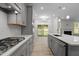 Modern kitchen boasts stainless steel appliances, sleek cabinetry, and a gas range stovetop at 2329 Field Poppy Dr, Apex, NC 27502