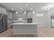Modern kitchen boasts stainless steel appliances, center island, and gray cabinets with modern hardware at 2329 Field Poppy Dr, Apex, NC 27502
