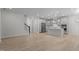 Bright, open-concept living room and kitchen featuring hardwood floors and neutral paint at 2329 Field Poppy Dr, Apex, NC 27502