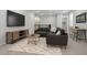Living room with gray sofa, entertainment center, and desk at 2329 Field Poppy Dr, Apex, NC 27502