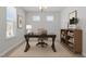 Well-lit home office with a large desk, comfortable chair, and shelving unit for organization at 2329 Field Poppy Dr, Apex, NC 27502
