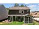 Back view of a modern home featuring a screened-in porch and well-manicured backyard at 2329 Field Poppy Dr, Apex, NC 27502