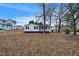 Charming single-story home featuring black shutters, white siding, and a cozy front porch at 2400 Dorety Pl, Raleigh, NC 27604