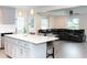 Open concept living area with eat-in kitchen island and leather sofa at 250 Patterson Dr, Roxboro, NC 27573