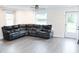 Bright living room featuring a large sectional sofa and updated flooring at 250 Patterson Dr, Roxboro, NC 27573