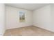 Comfortable bedroom with neutral carpeting and a view of the outdoors through a window at 261 Johnson Ridge Way, Four Oaks, NC 27524