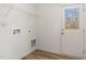 A bright mud room with white walls and wood floors featuring a back door to the property's exterior at 261 Johnson Ridge Way, Four Oaks, NC 27524