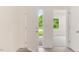 Bright entryway featuring a modern door and wood-look floors, leading into a carpeted living space at 284 Johnson Ridge Way, Four Oaks, NC 27524