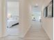 Bright hallway with wood floors, connecting the bedroom to the living area, adorned with artwork at 284 Johnson Ridge Way, Four Oaks, NC 27524