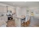 Beautiful kitchen featuring stainless steel appliances, gray cabinets, and granite countertops with eat in island at 284 Johnson Ridge Way, Four Oaks, NC 27524