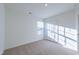 Neutral carpeted bedroom featuring a window with blinds and a closet with double doors at 285 Johnson Ridge Way, Four Oaks, NC 27524