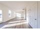 Well-lit living room with hardwood floors, white walls, and a view of the outdoors at 285 Johnson Ridge Way, Four Oaks, NC 27524