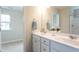 Bathroom with dual sinks, white cabinets, and modern fixtures, providing a clean and functional design at 296 Johnson Ridge Way, Four Oaks, NC 27524