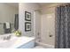 Bathroom featuring framed wall art, white vanity, and a tub/shower combo at 296 Johnson Ridge Way, Four Oaks, NC 27524
